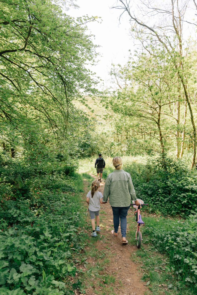 family walking through woodland at yeatheridge