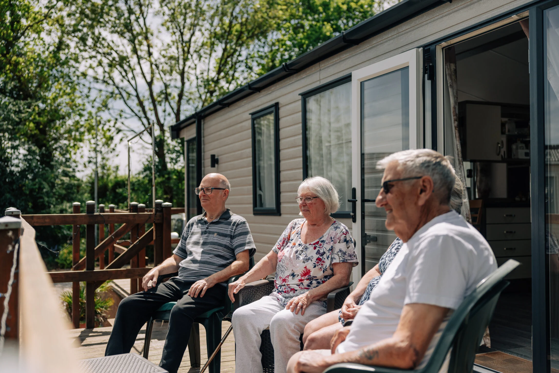 friends sat outside holiday home