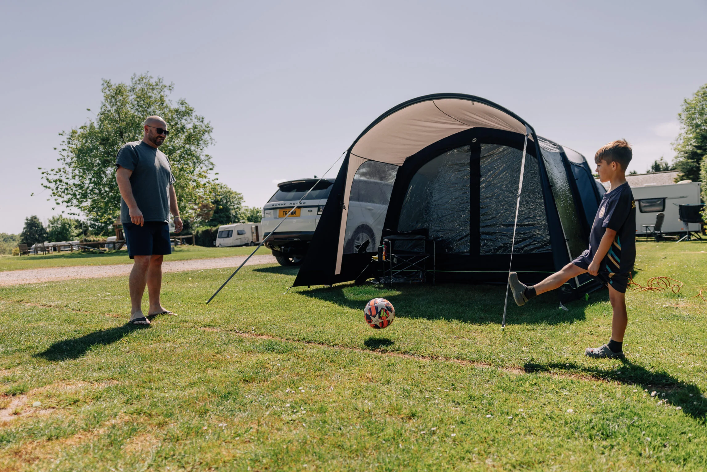 playing football next to tent