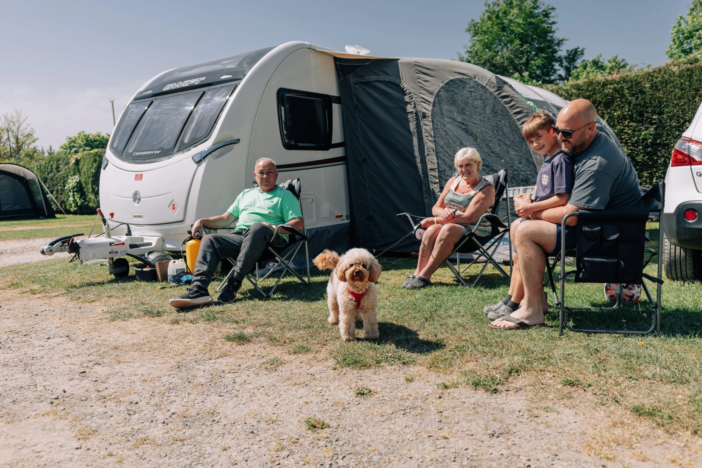 family sat outside caravan at yeatheridge