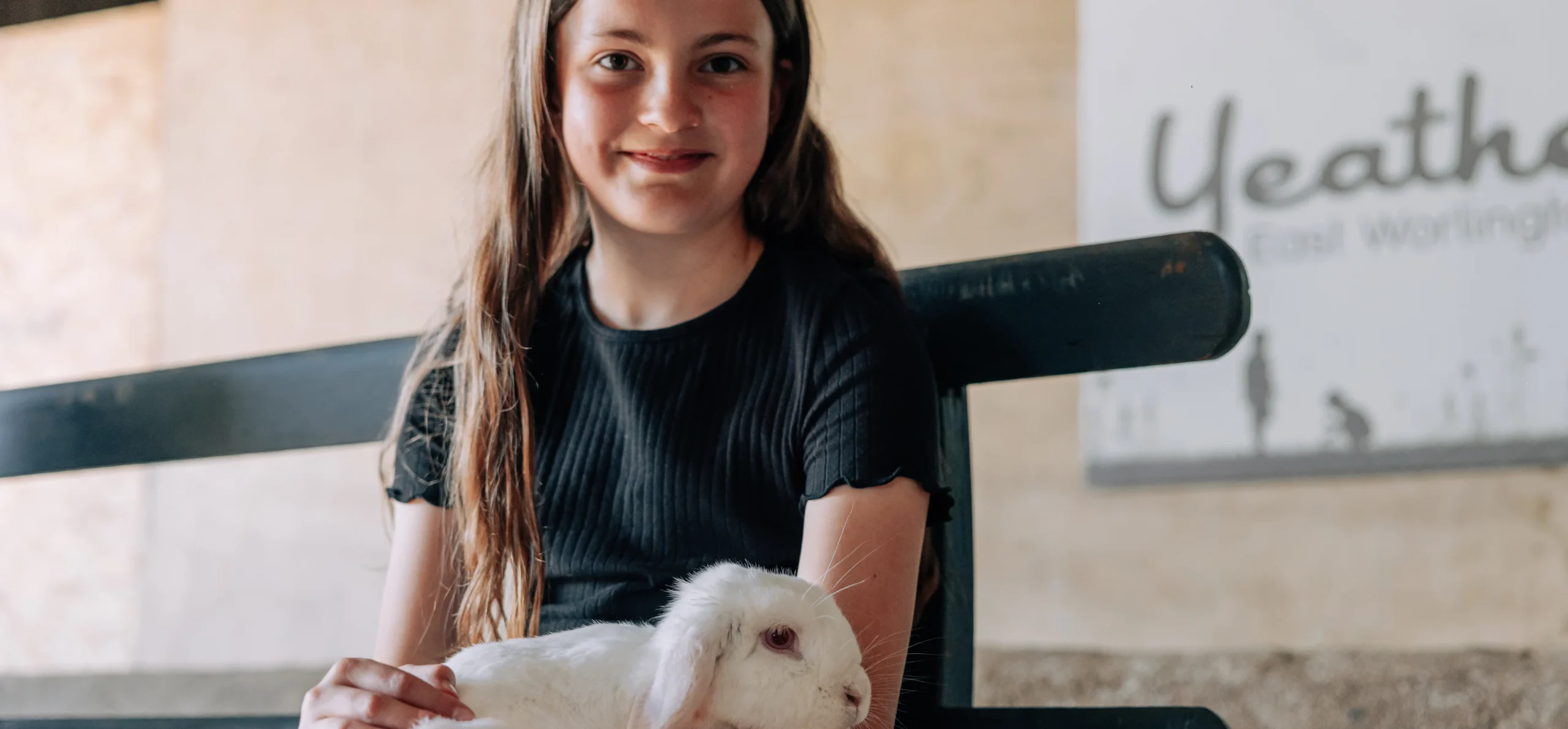 girl holding bunny rabbit